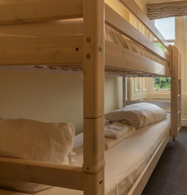 Room with bunk beds and a window